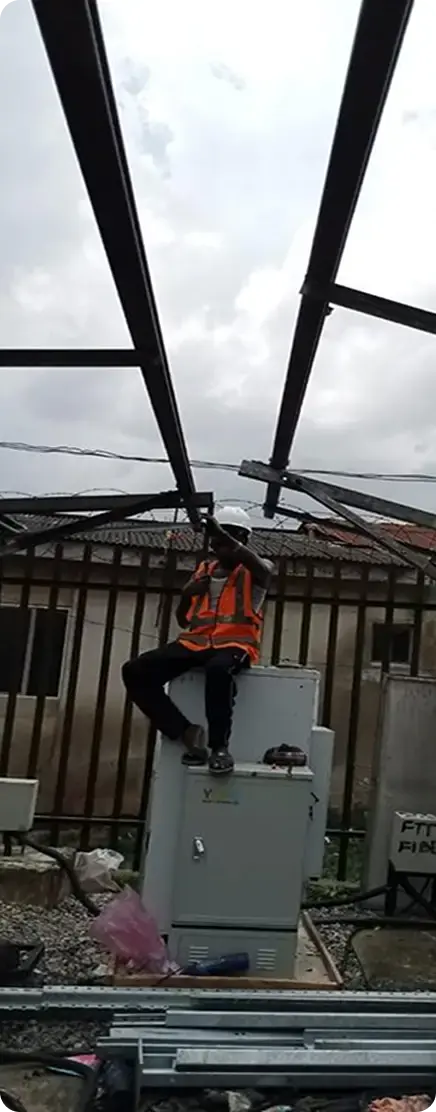 a lady engineer standing in front of installed solar panel