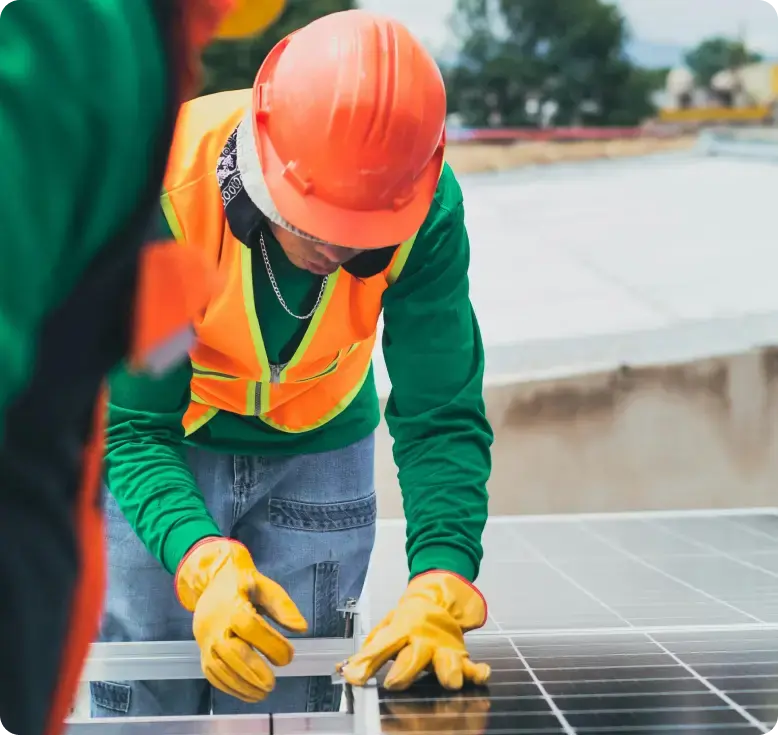  a man putting on an helmet working on a solar panel